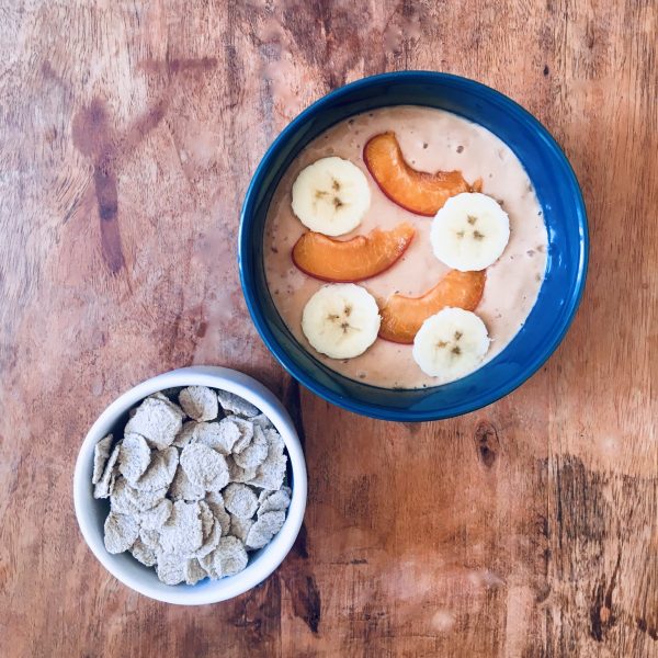 Apricot smoothie bowl and buckwheat flakes